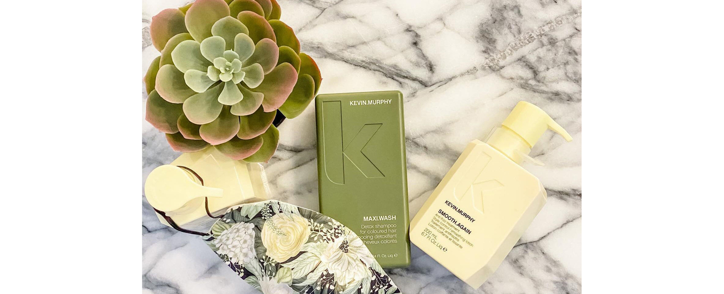 KEVIN.MURPHY haircare products with a succulent on marble, indicating natural hair treatments.